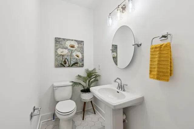 a bathroom with a toilet sink and mirror
