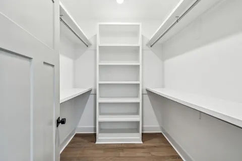 a view of walk in closet with empty racks