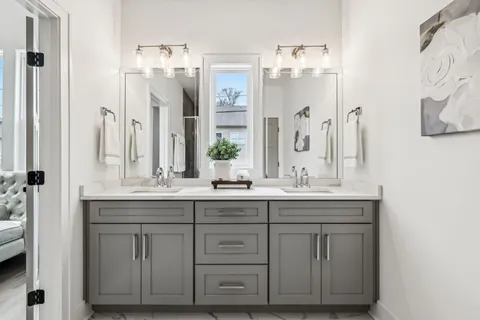a bathroom with a double vanity sink and mirror