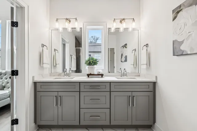 a bathroom with a double vanity sink and mirror