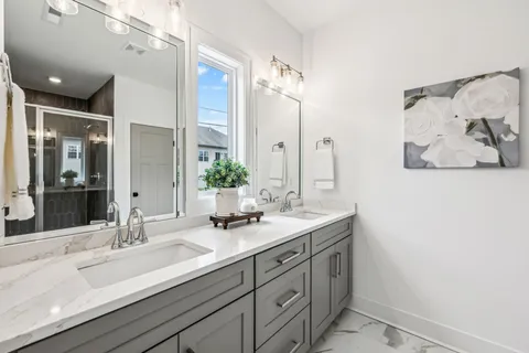 a bathroom with a double vanity sink and a mirror