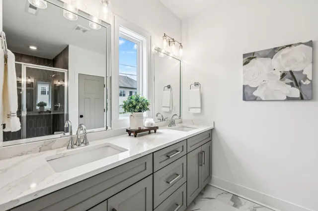 a bathroom with a double vanity sink and a mirror