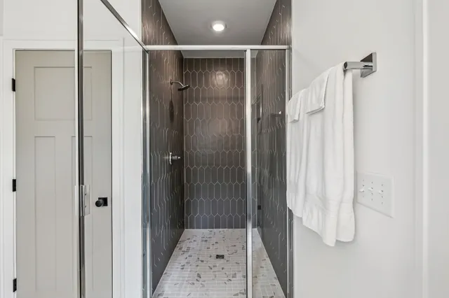 a bathroom with a shower and a glass door