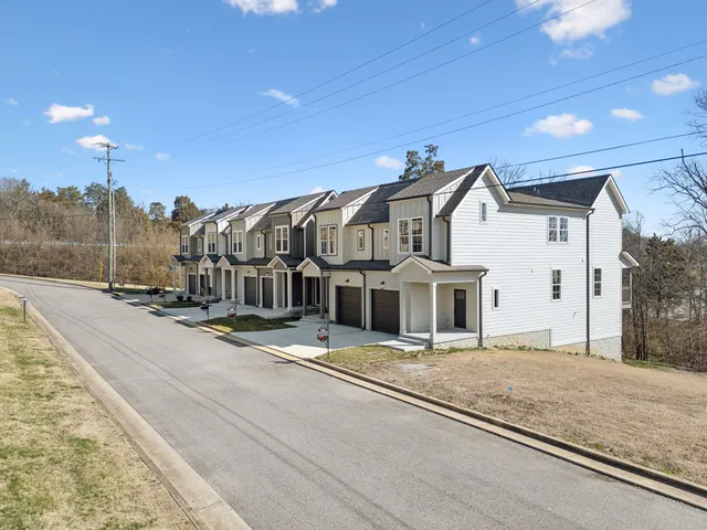 a view of a house next to a yard