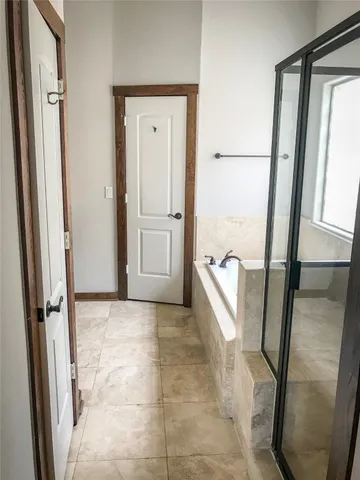 a bathroom with a glass shower door