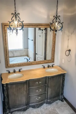 a white bath tub sitting in a bathroom next to a window