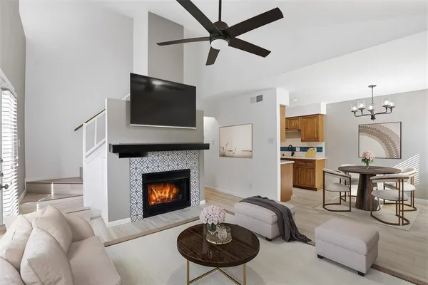 a living room with furniture a rug and a fireplace