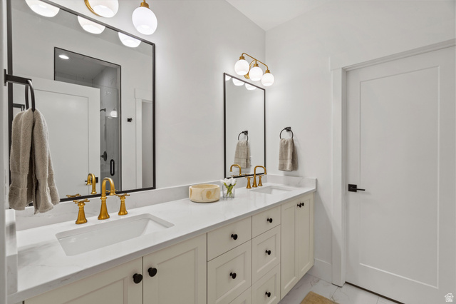 3349 Oxford Loop Morgan, UT 84050 - Photo 18 of 47 Bathroom featuring double vanity, light marble finish flooring, and a stall shower