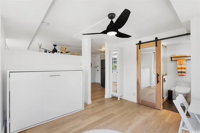 a bedroom with a bed and a large mirror