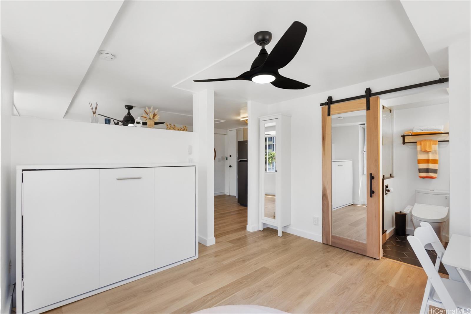 2888 Ala Ilima Street, Unit 611 Honolulu, HI 96818 - Photo 13 of 22 a bedroom with a bed and a large mirror