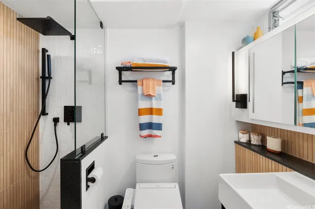 a bathroom with a shower a toilet and a sink