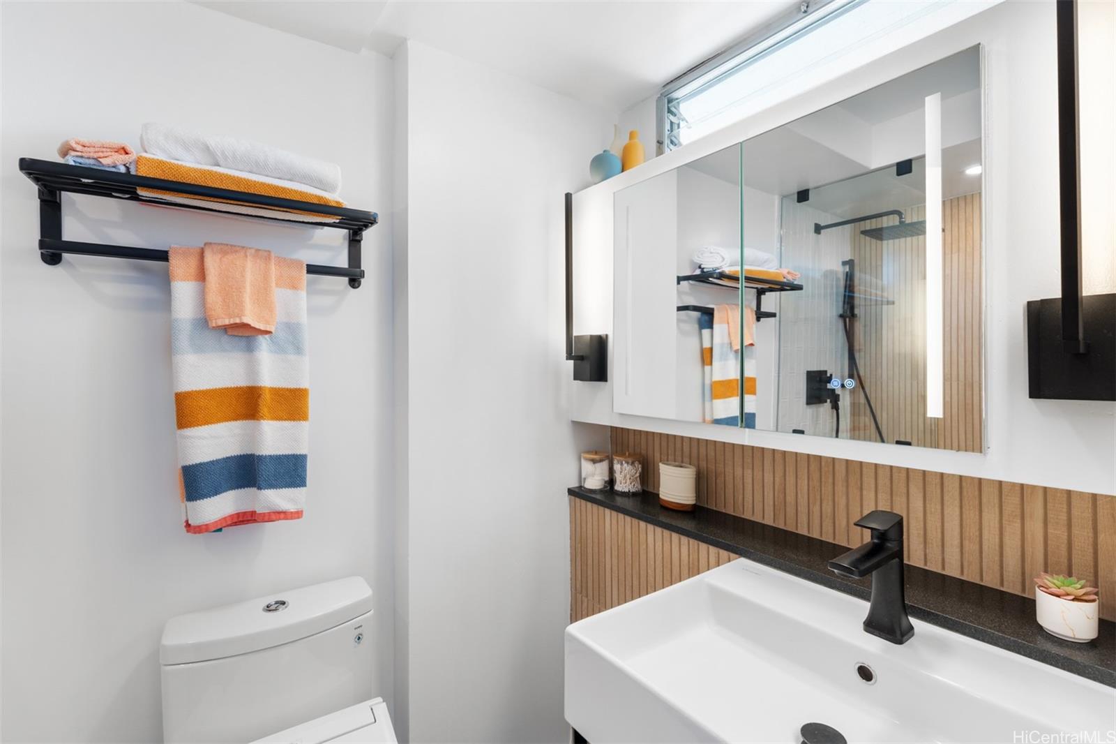 2888 Ala Ilima Street, Unit 611 Honolulu, HI 96818 - Photo 17 of 22 a bathroom with a sink a mirror and shower curtain