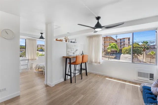 a view of a livingroom with furniture window and wooden floor
