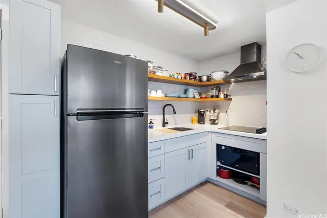 a kitchen with stainless steel appliances granite countertop a refrigerator and a sink