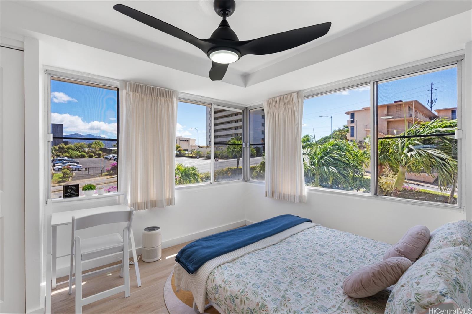 2888 Ala Ilima Street, Unit 611 Honolulu, HI 96818 - Photo 9 of 22 a bedroom with a bed and a large window