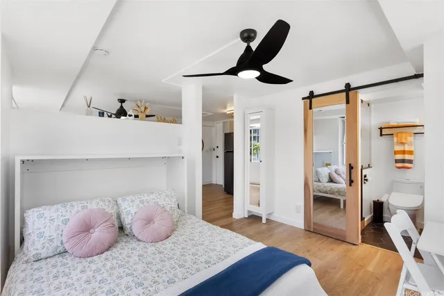 a bedroom with furniture and a large mirror