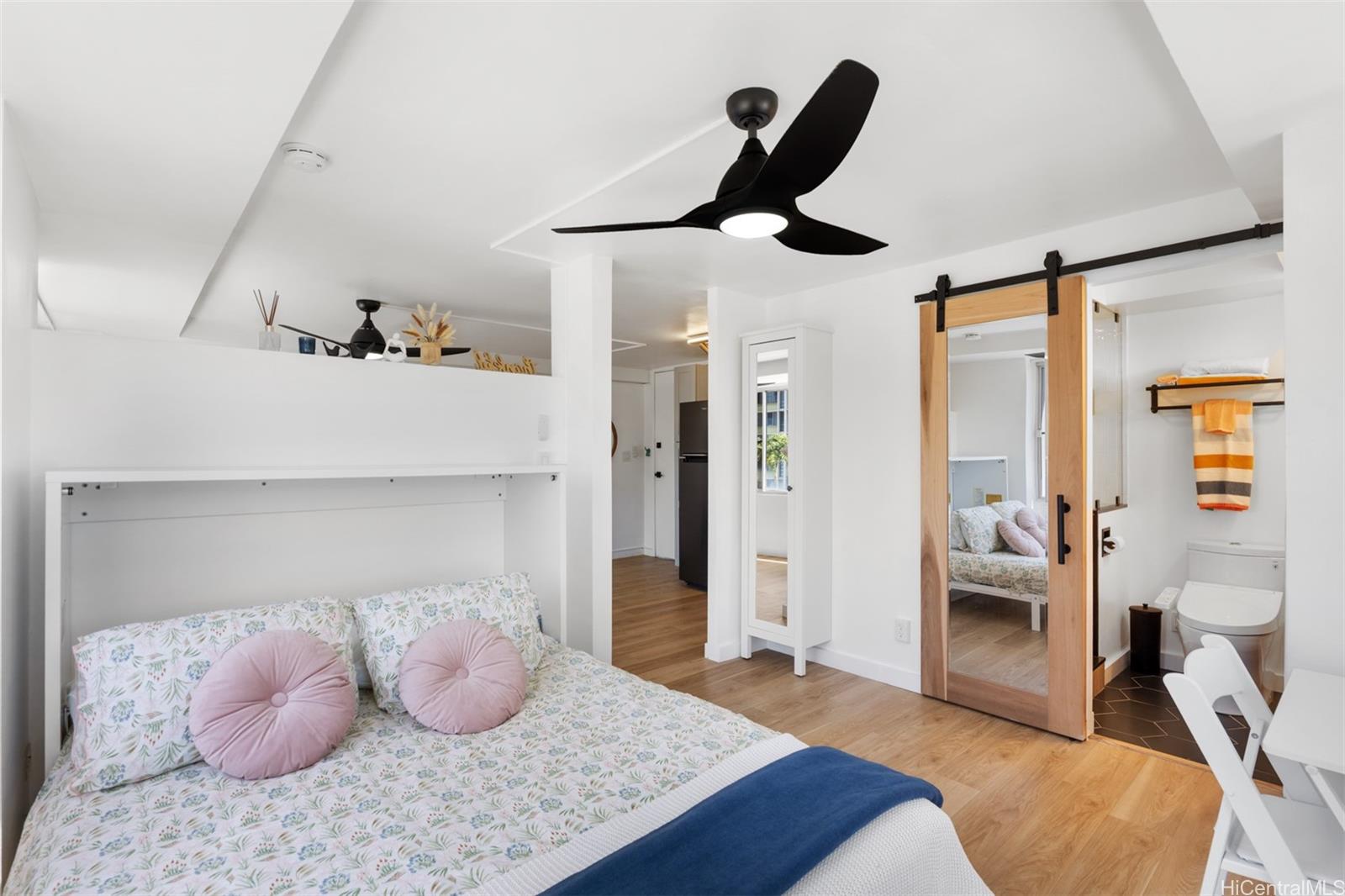 2888 Ala Ilima Street, Unit 611 Honolulu, HI 96818 - Photo 10 of 22 a bedroom with furniture and a large mirror