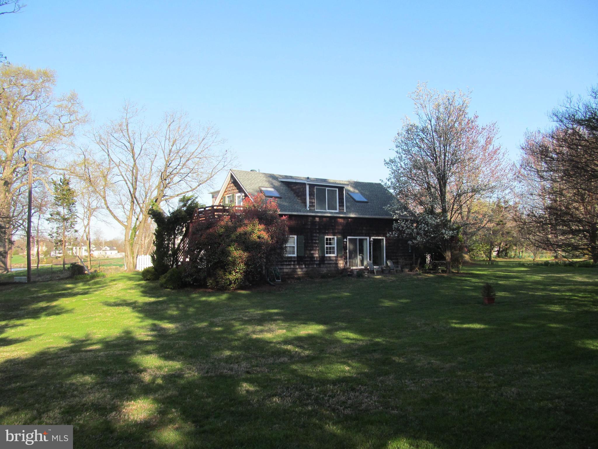 1413 Sharps Point Road Annapolis, MD 21409 - Photo 15 of 29 a backyard of a house with lots of green space and garden