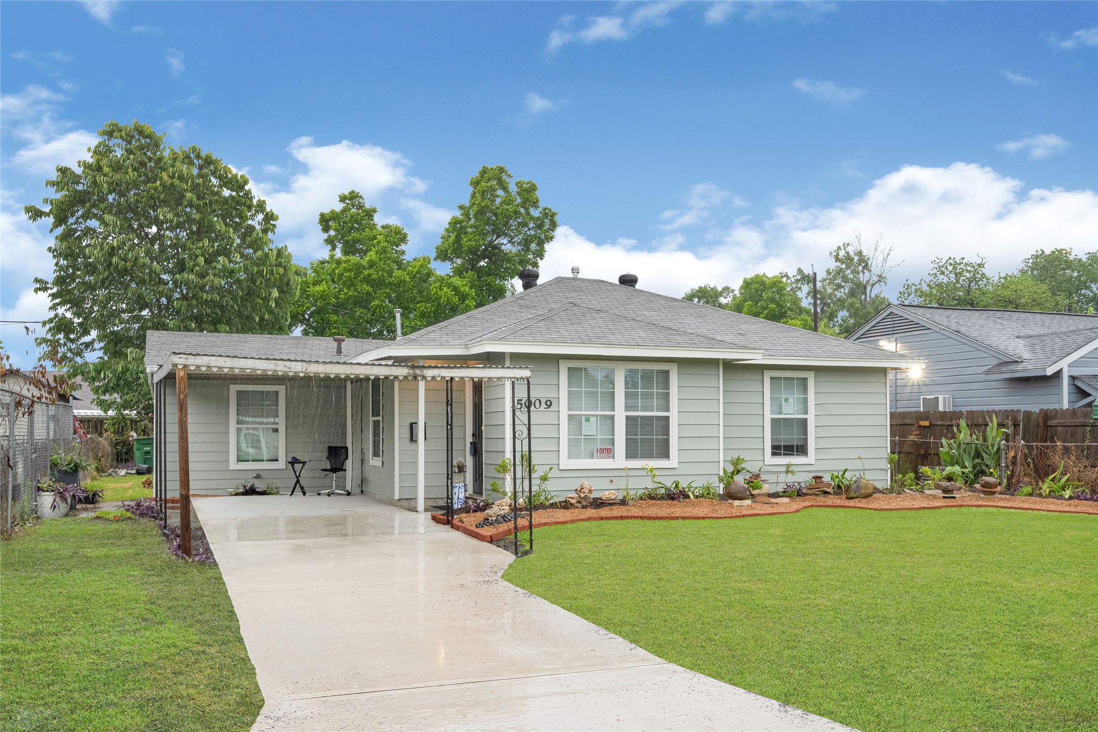 a front view of a house with a garden and yard