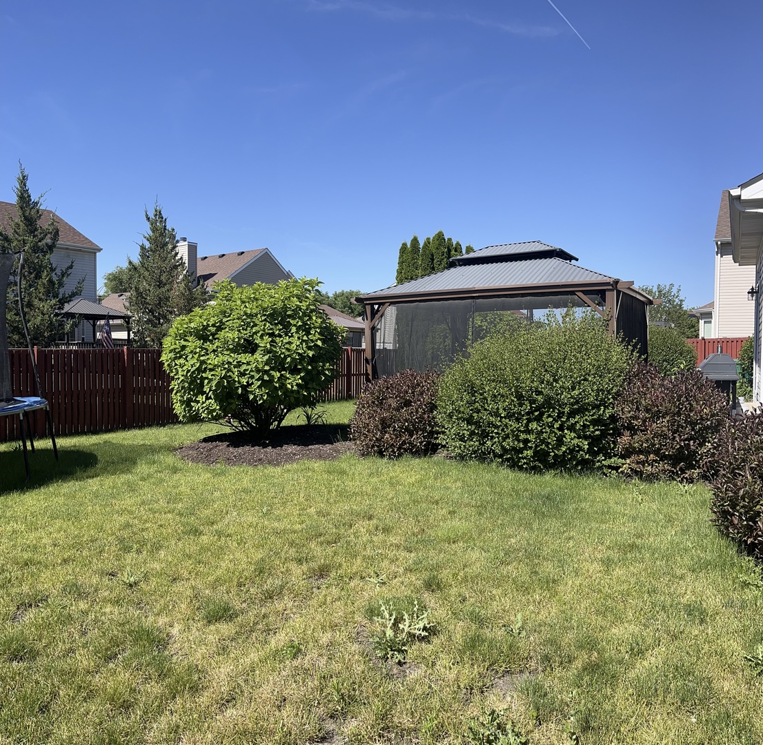 1939 Ashbrooke Road Romeoville, IL 60446 - Photo 17 of 20 a backyard of a house with lots of green space