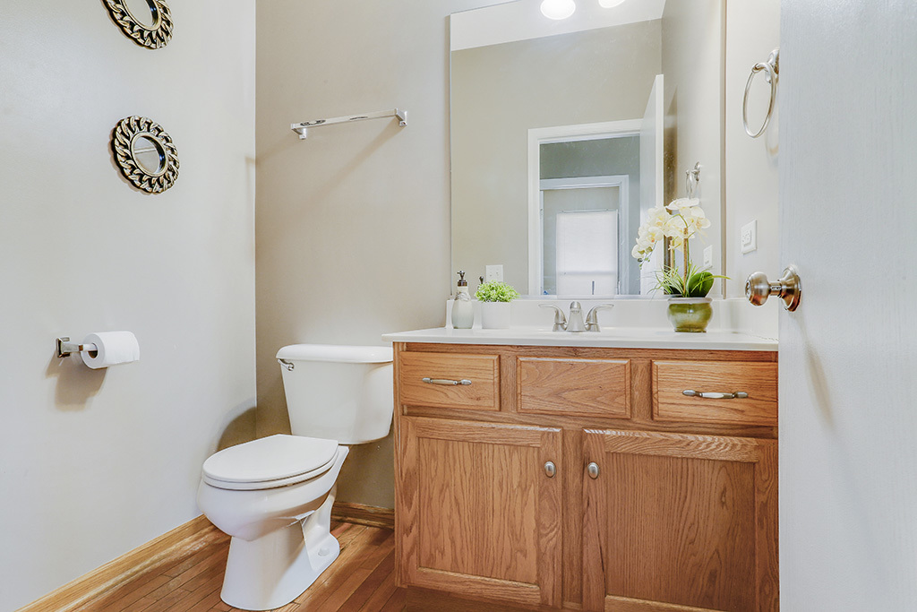 1939 Ashbrooke Road Romeoville, IL 60446 - Photo 6 of 20 a bathroom with a toilet sink and mirror