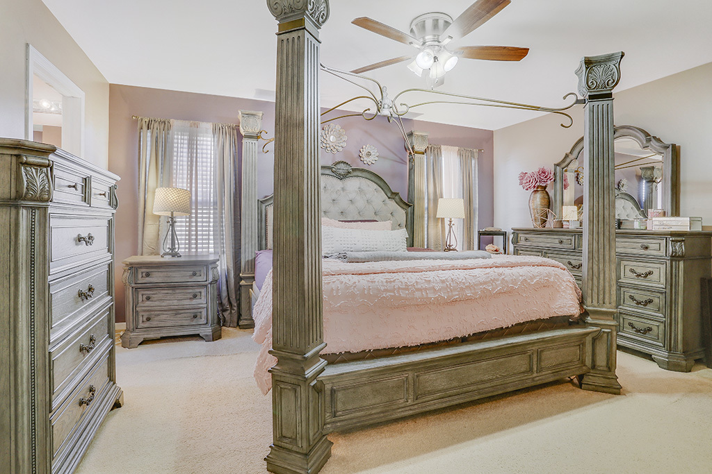 1939 Ashbrooke Road Romeoville, IL 60446 - Photo 7 of 20 a bedroom with furniture and a chandelier