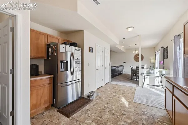 a kitchen with stainless steel appliances granite countertop a refrigerator and a stove