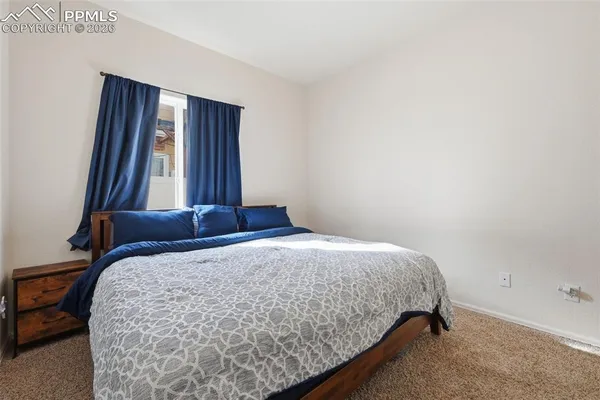 a bedroom with a bed and window