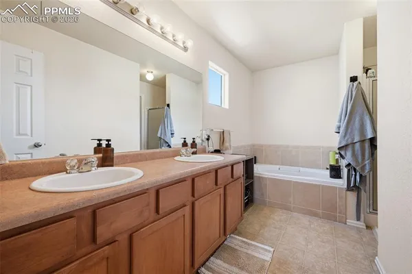 a bathroom with a double vanity sink and a bathtub