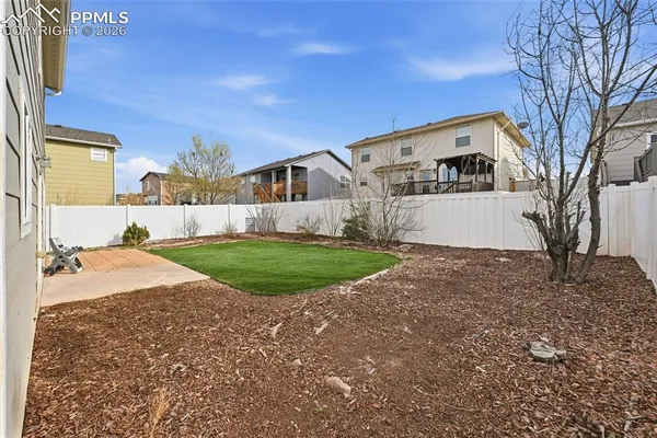 a view of house with backyard