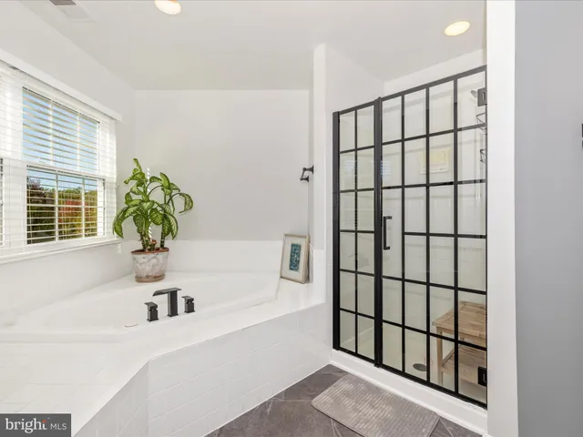 a bedroom with a bed and a chair