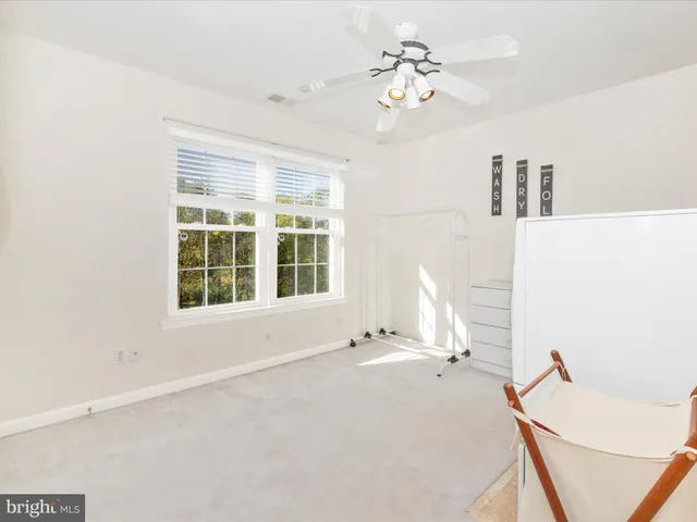 a view of a hallway with furniture and a chandelier