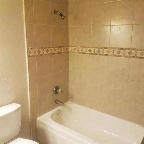 a bathroom with a bathtub and a toilet