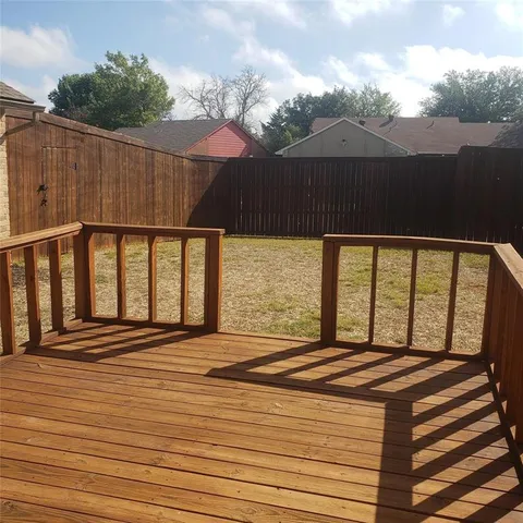 a view of a room with wooden floor and a floor to ceiling window