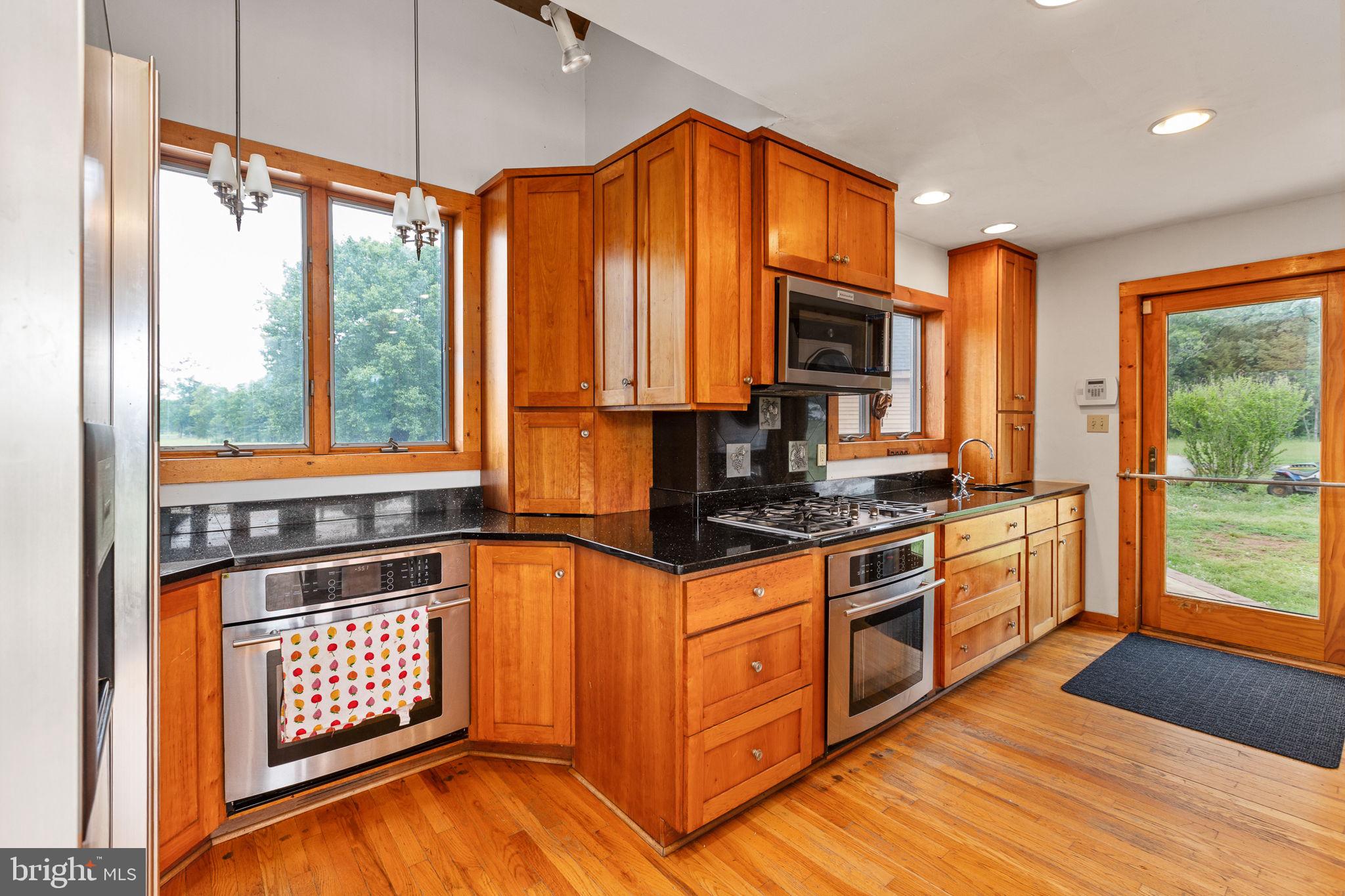 6119 Beach Road Midland, VA 22728 - Photo 39 of 98 a kitchen with stainless steel appliances granite countertop a stove a sink and a microwave
