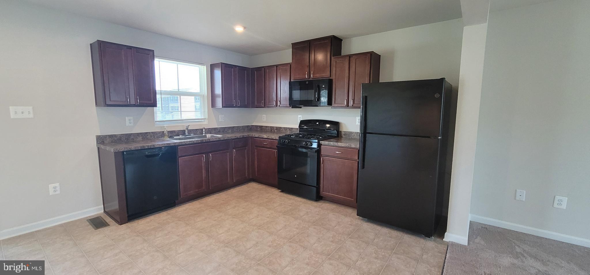 67 Wiggles Court Martinsburg, WV 25403 - Photo 5 of 18 a kitchen with stainless steel appliances granite countertop a refrigerator a sink dishwasher a stove top oven a refrigerator and cabinets
