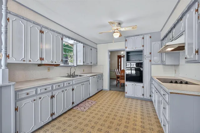 a kitchen with cabinets and window