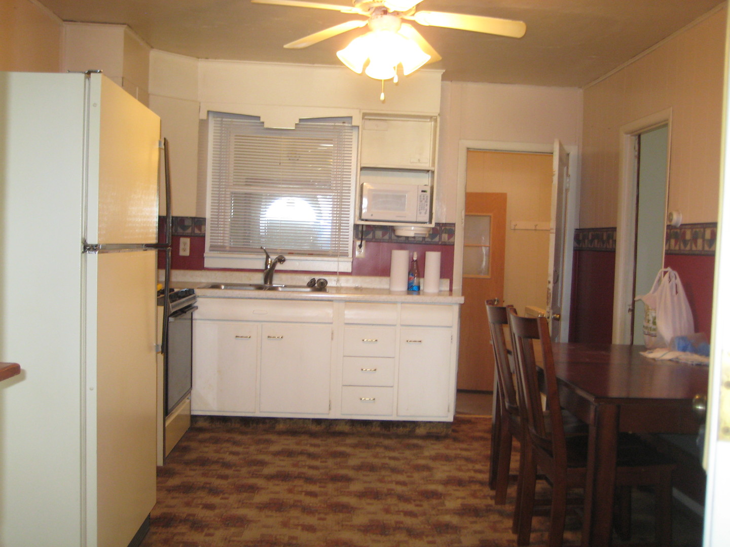 1691 Hoover Road Deer Grove, IL 61243 - Photo 3 of 12 a kitchen with sink cabinets and refrigerator