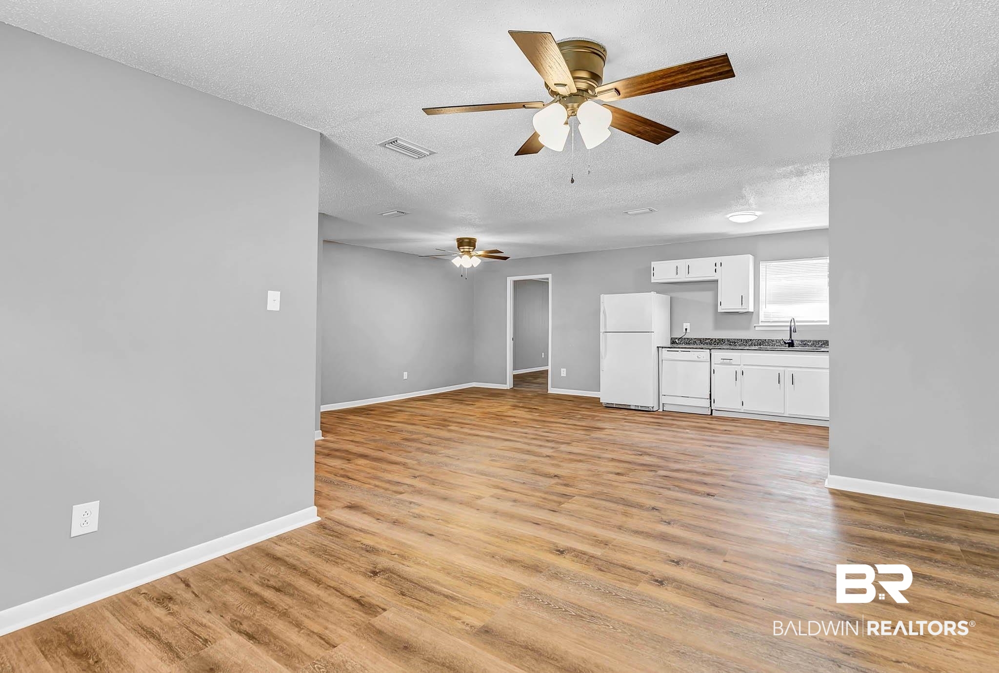 3304 Armond Drive Mobile, AL 36605 - Photo 11 of 62 Unfurnished living room with ceiling fan, a textured ceiling, and light wood-style flooring