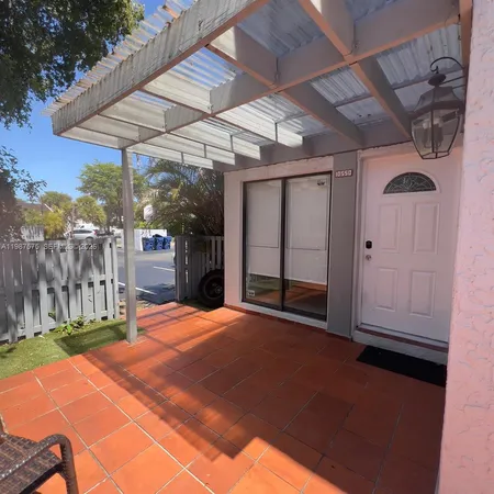 a view of a backyard with table and chairs under an umbrella