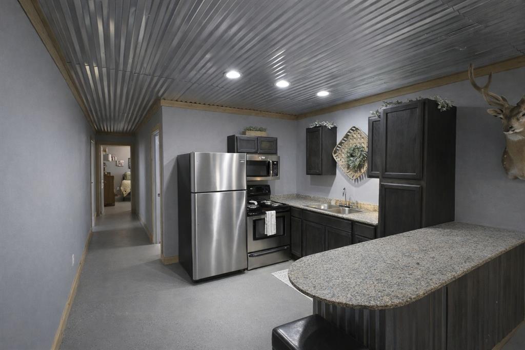 1011 Red Road Howe, TX 75459 - Photo 24 of 39 a kitchen with refrigerator and kitchen island
