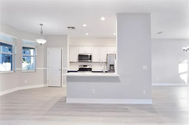 a view of a living room and kitchen view