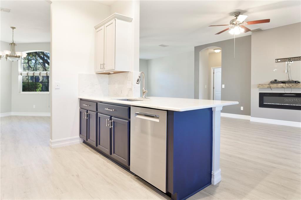 2560 Tall Maple Loop Ocoee, FL 34761 - Photo 14 of 32 a kitchen with stainless steel appliances granite countertop a stove a sink and a refrigerator