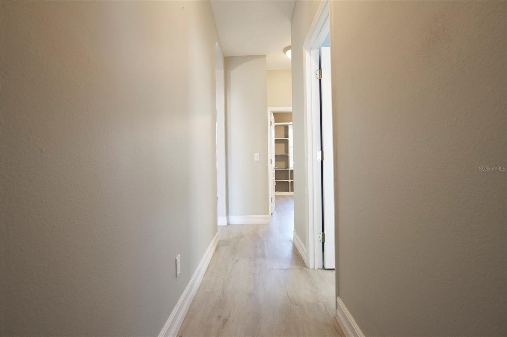 2560 Tall Maple Loop Ocoee, FL 34761 - Photo 16 of 32 a view of a hallway with wooden floor