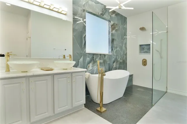 a bathroom with a double vanity sink toilet and shower