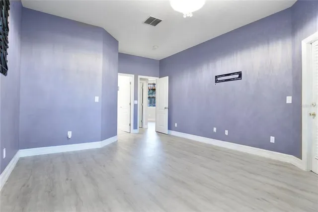 a view of a room with wooden floor and windows