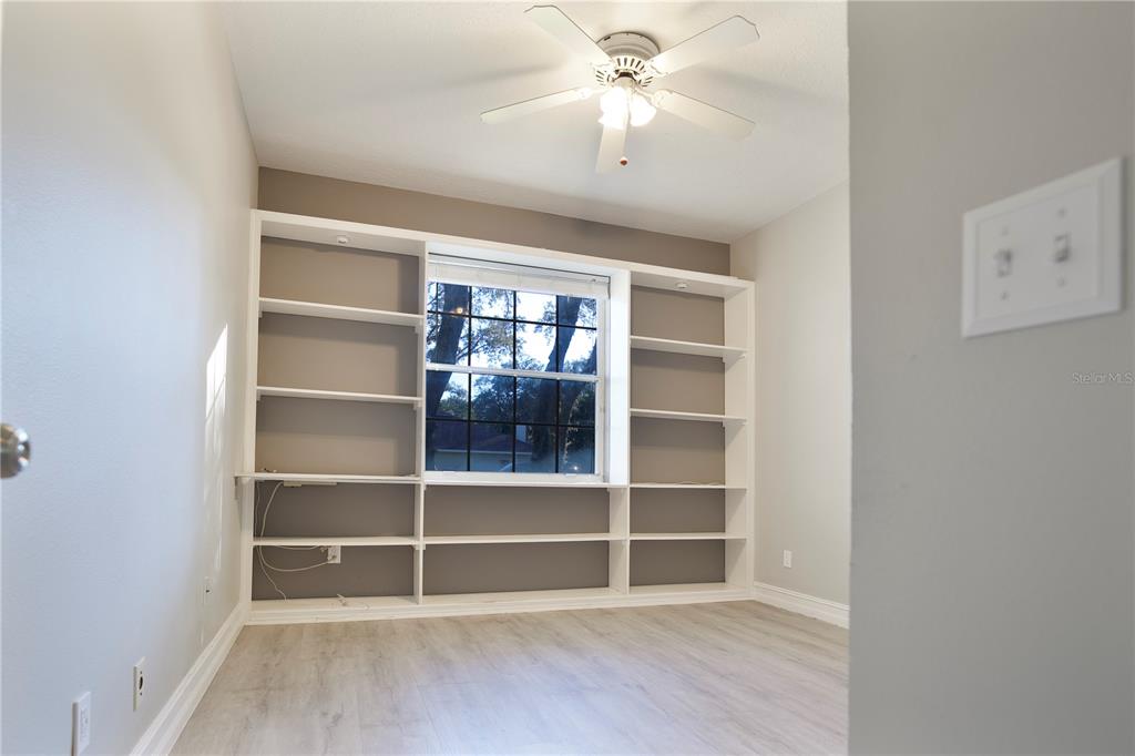 2560 Tall Maple Loop Ocoee, FL 34761 - Photo 24 of 32 a view of an empty room with a window and wooden floor