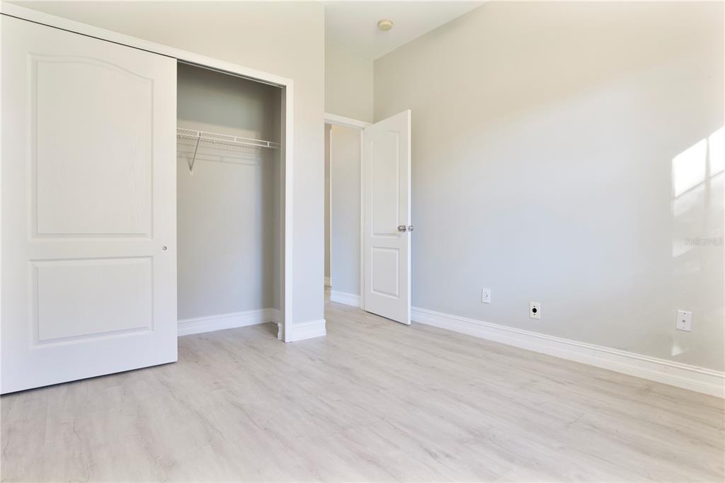 2560 Tall Maple Loop Ocoee, FL 34761 - Photo 25 of 32 an empty room with wooden floor and closet