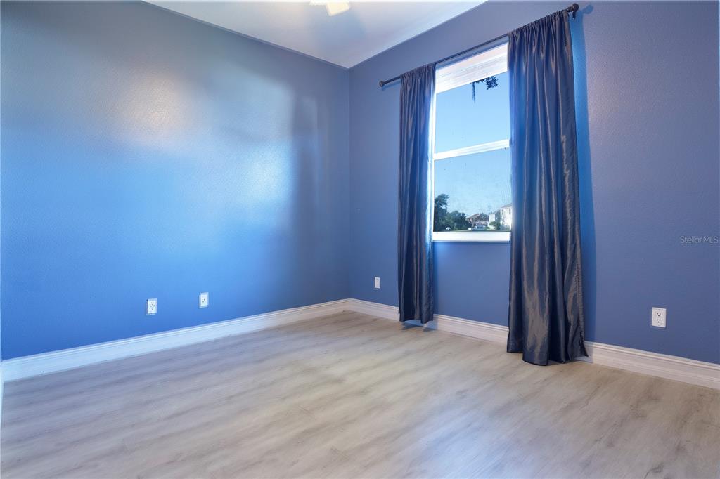 2560 Tall Maple Loop Ocoee, FL 34761 - Photo 26 of 32 an empty room with wooden floor and windows
