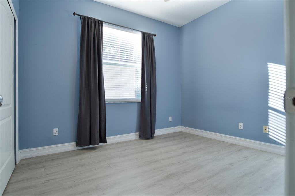 2560 Tall Maple Loop Ocoee, FL 34761 - Photo 27 of 32 an empty room with wooden floor and windows